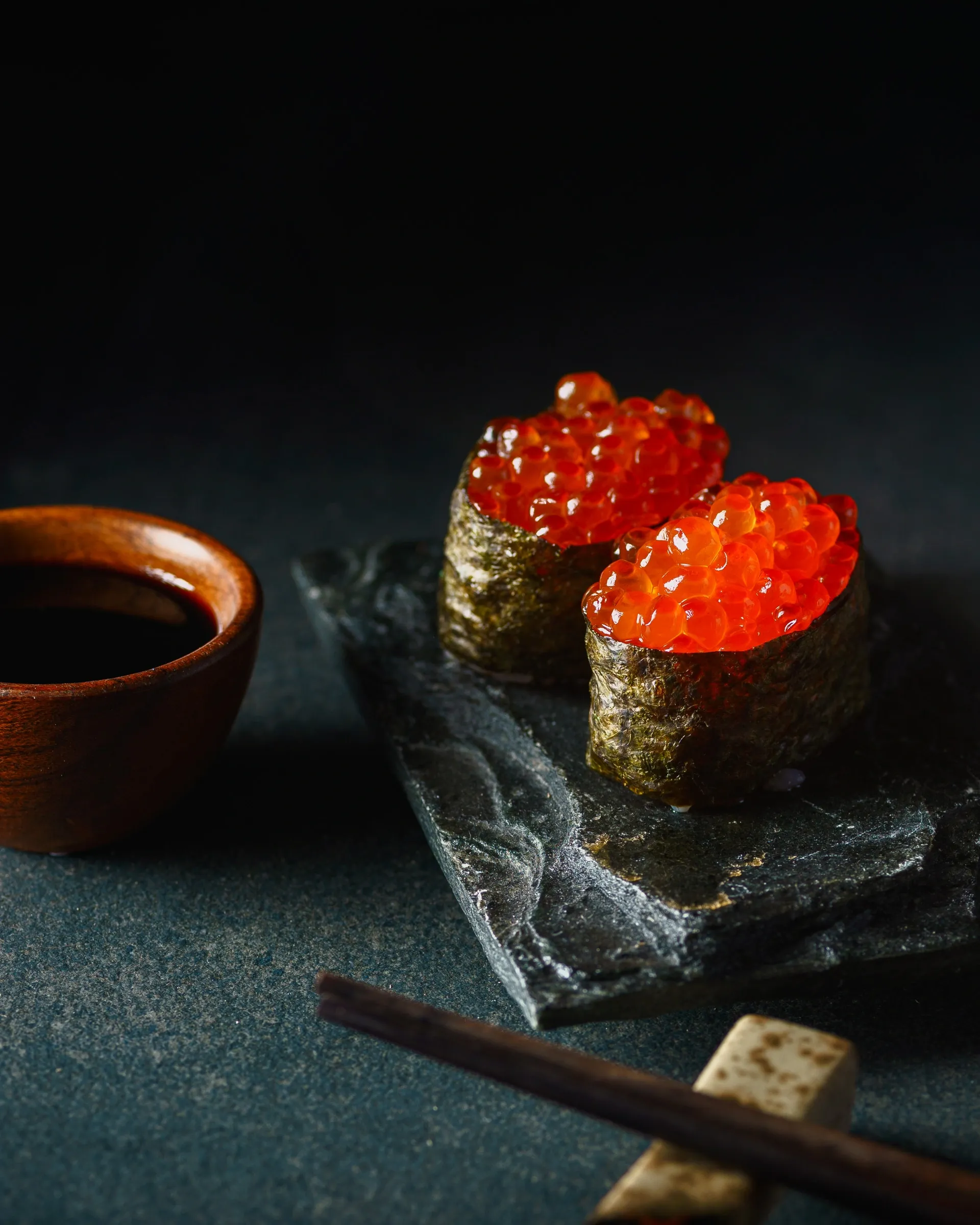 Salmon roe sushi in dramatic lighting