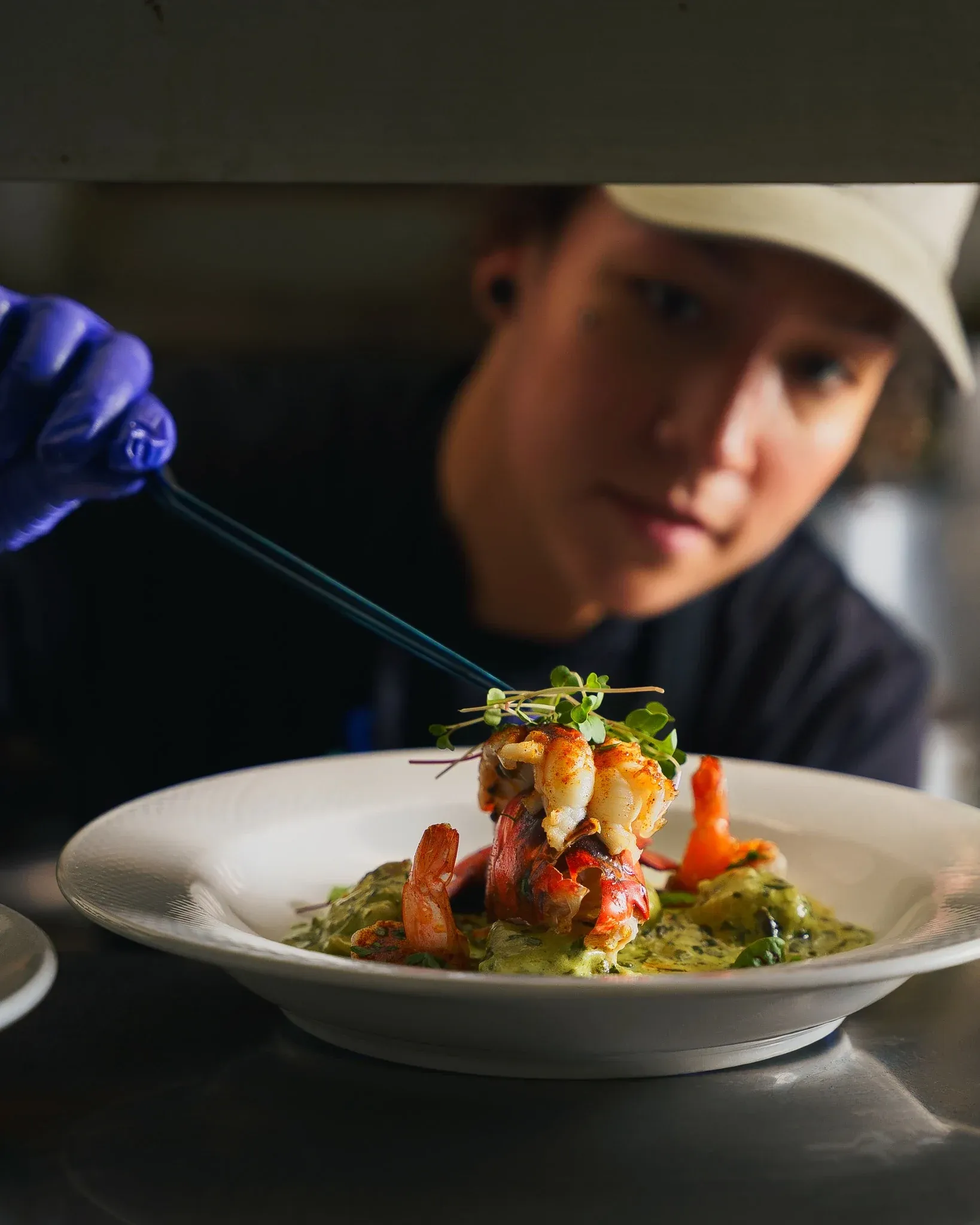 Executive Chef plating a lobster dish at Collage in St. Augustine